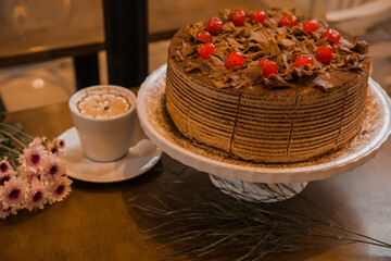 cherry and chocolate cake, wish coffee cup, selective focus
