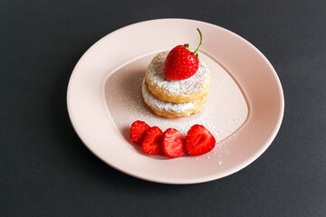 Delicious cheesecakes pancakes, decorated with fresh strawberries. Horizontal orientation.