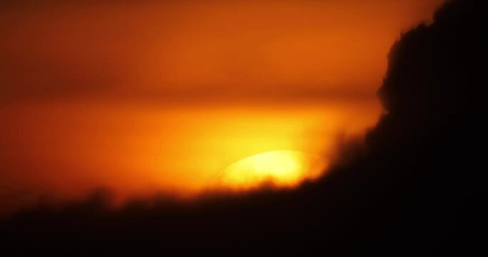 
Beautiful sunset video. Orange sky on which the yellow sun sets behind the clouds. Romantic video for background.