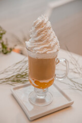 special coffee cup with cream and spices on light background