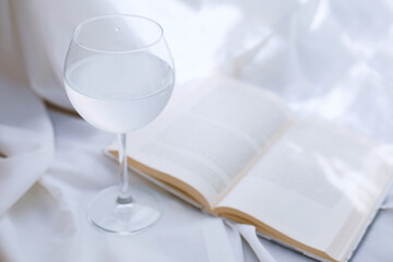 Glass of water and book