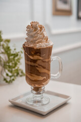 special coffee cup with cream and spices on light background