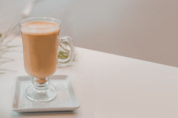 special coffee cup with cream and spices on light background