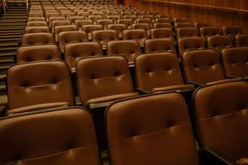 Theater or cinema auditorium with empty padded seats