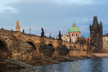 Fototapeta na wymiar Panorama of the city of Prague, Czech Republic on a sunny day. View of Charles Bridge and the bank of the Vltava River.