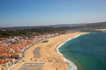 Fototapeta na wymiar View of the beach ocean surf and town in Nazare Portugal