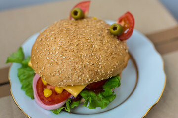 Big and tasty hamburger on plate isolated on white