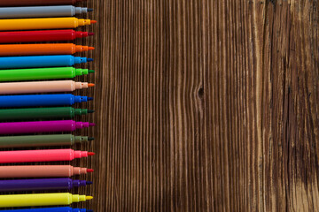 Colorful pencils on the wooden background for back to school concept.