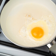 Egg fried in a pan with a white ceramic non-stick coating