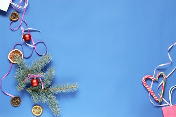 Merry Christmas, bright blue background with New Year's decor, caramel heart and space for an inscription, top view