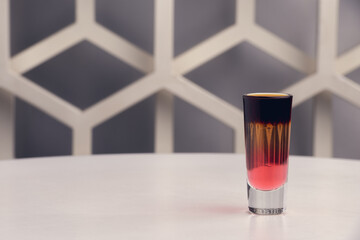 Fruit shots on white table with modern design bar background
