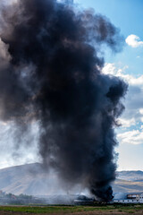 Fototapeta na wymiar a huge factory fire. black fumes and flames