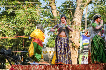 different statues of traditional Indian women ride on open platform at religion feast