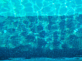 Blue aqua in swimming pool with rippled water, pure water in pool