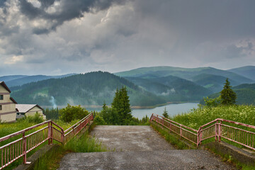 Down the stairs to the lake Vidra in mountains