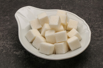 Refined white sugar cubs in the bowl