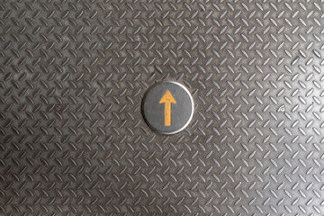 Yellow arrow, iron background