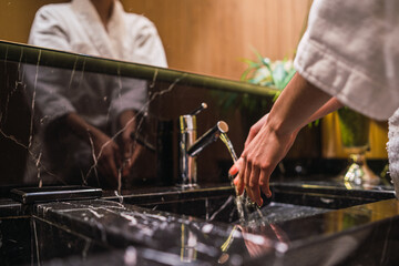 Young woman standing in the spa bathroom.