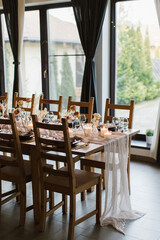 Beautiful stylish wedding with a beautiful decorated banquet table with fresh flowers. Wedding dinner. Served in a restaurant.