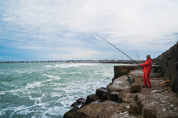 Old man fishing in the sea.