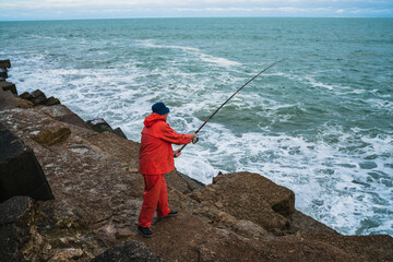 Old man fishing in the sea.