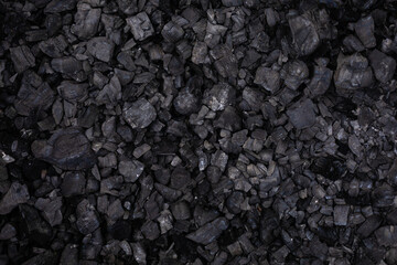 Black coal background top view selective focus