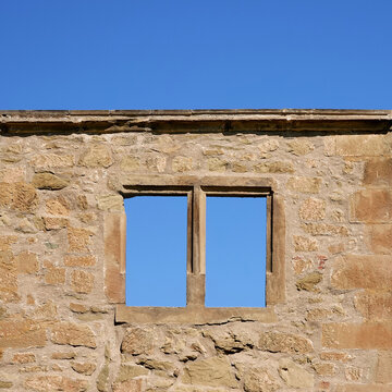 Brown window in a brick castle, blue sky. Germany.