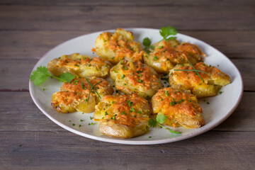 Smashed new baby potatoes with garlic and cheese. Healthy vegetarian food