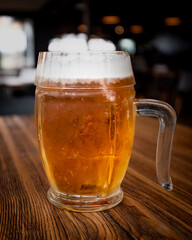 mug of beer on a wooden table in a pub

