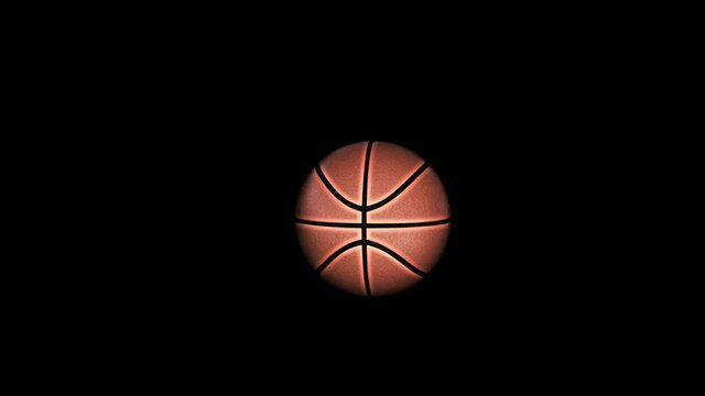 Basketball flying in slow motion against black