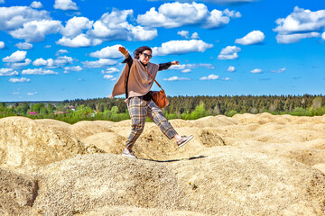 Elegant woman on the background of the Martian landscape. Bornitsky quarry. The village of New Khinkolovo, Gatchinsky district, Leningrad region. Russia