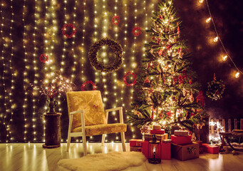 Traditional decorated living room on Christmas Eve. Lot of party lights illuminated, decorated tree with one vintage chair and lot of red and cold color presents stacked. 