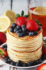 A stack if home-made pancakes with berry