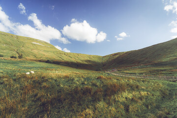 Gleniff Horseshoe Drive, Sligo Ireland. The shadows move across the rolling hills as the track winds its way up to the cottage nestled in the valley.