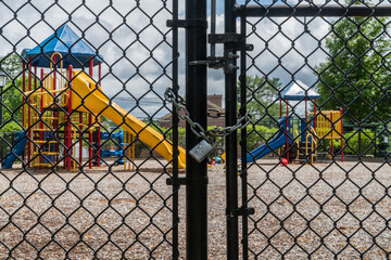 Empty playground with locked fence during Covid-19 era.