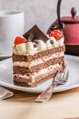 chocolate cake with cream and cherries wooden table whit tea