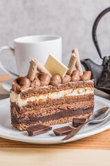chocolate and cream cake on wooden table whit tea