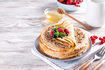 Crepes with berries and poppy seeds. Maslenitsa - a traditional Russian and Ukrainian holiday