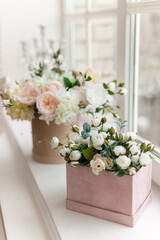 Fototapeta na wymiar beautiful flowers in vases on old wooden windowsill