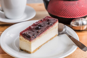 cheesecake on wooden table with tea