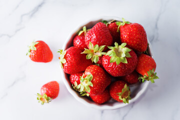 Raw fresh strawberries on a light background