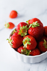 Raw fresh strawberries on a light background