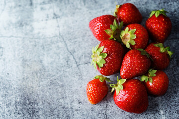 Raw fresh strawberries on a light background