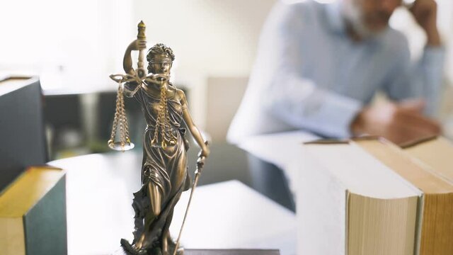 The Statue of Justice - lady justice or Iustitia / Justitia the Roman goddess of Justice in lawyer office