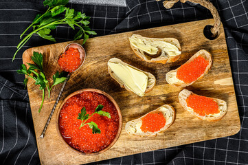 Sandwiches with salmon red caviar. Gray background. Top view