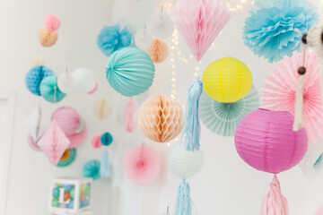 Party pom poms and paper lanterns. Cute party decorations.