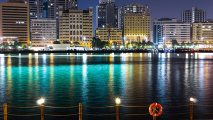 Fototapeta premium Long exposure landscape of old Dubai, UAE and the river and cruise light trails