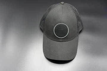 Black baseball cap with round space for logo. Top front view, isolated on gray background