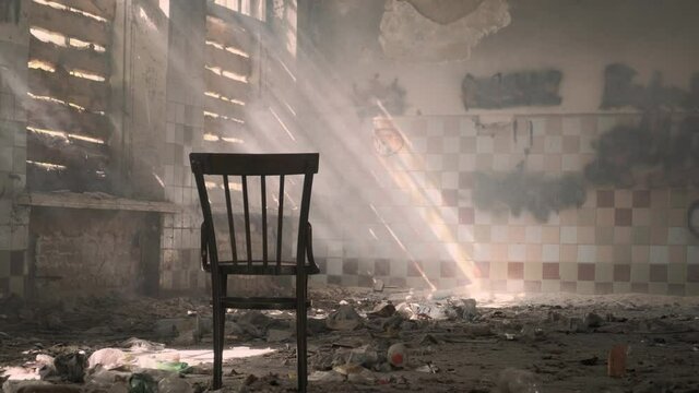 chair in abandoned building with boarded up windows in sun.