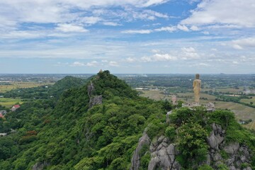 Fototapeta premium Buddhist statue rests above the mountain in Ratchaburi Thailand